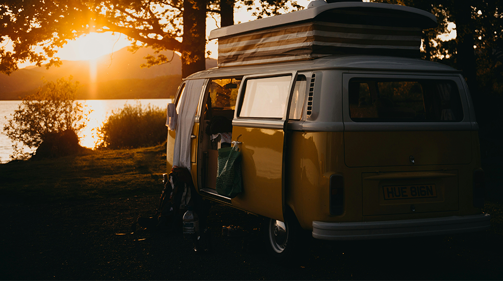 A VW camper van parked up during sunset